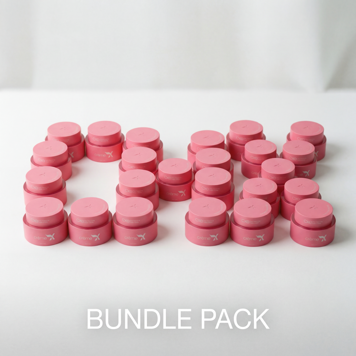 creamxemirates bundle of 20 pink round jars of luxury brightening and nourishing face cream arranged in a group with white text BUNDLE PACK